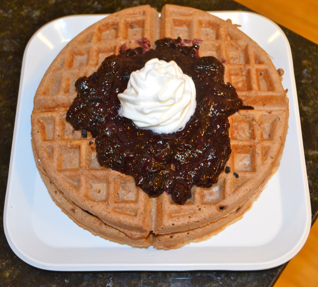 Chocolate Waffles topped with a berry mixture reduction and a little whipped cream! 